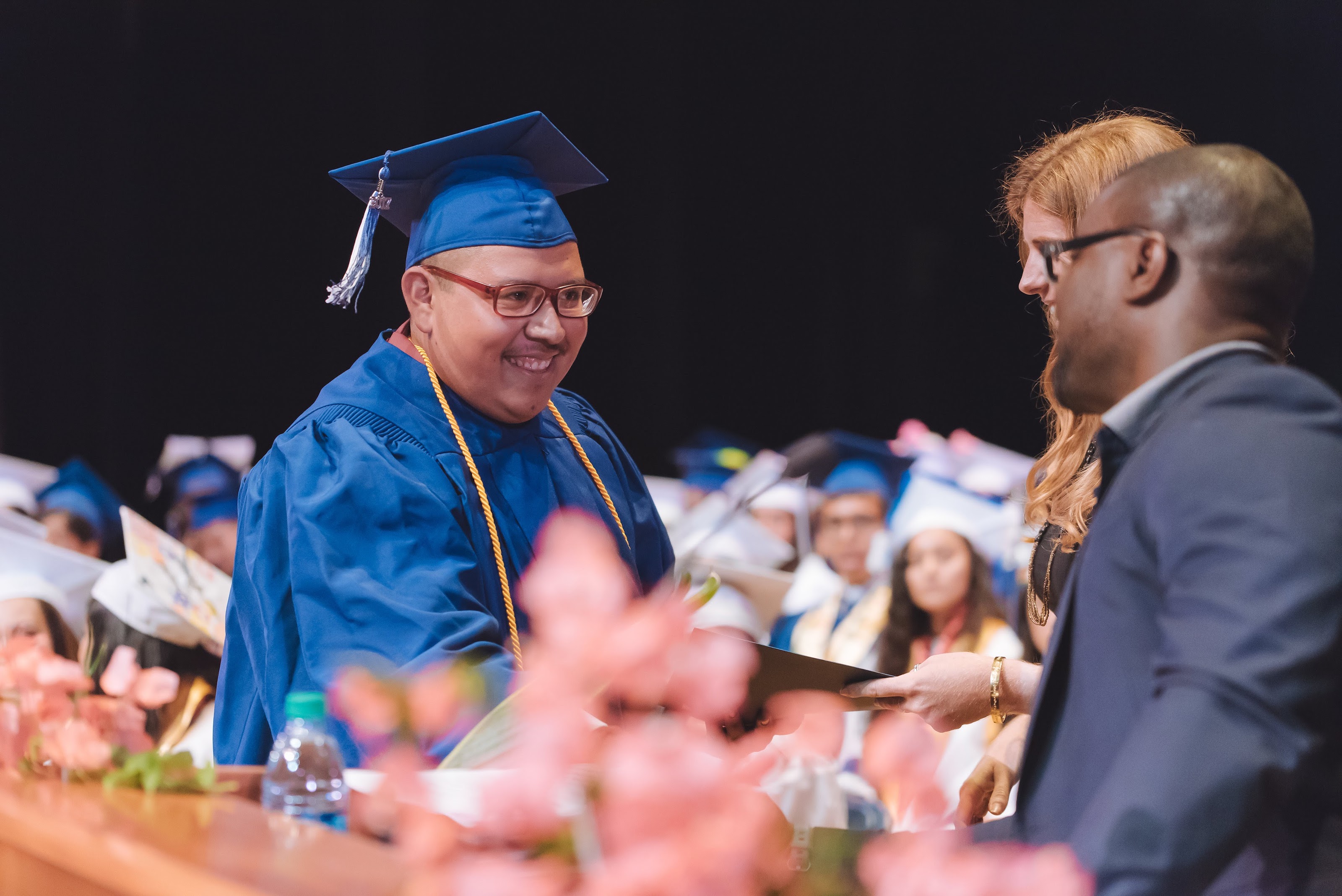 Photo: Angel Perez accepts his scholarship. 